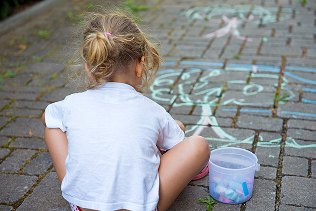 child is painting the street